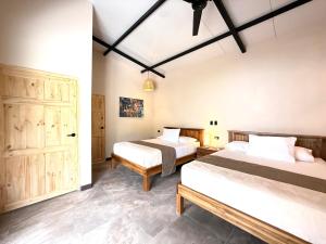 a bedroom with two beds in a room at Lalola de Puerto in Puerto Viejo +17 photos