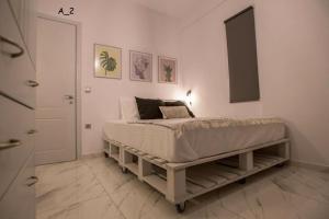 a bedroom with a bed in a white room at live it _ Karditsa in Karditsa
