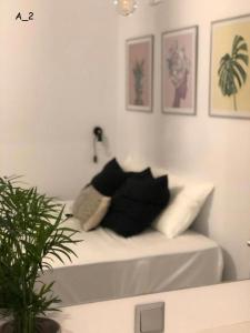 a white couch with black pillows in a living room at live it _ Karditsa in Karditsa