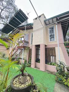 a house with a potted plant in front of it at Odara Pines Garden The Ridge House 1BR in Baguio +18 photos