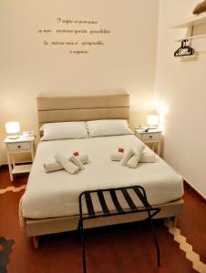 a bedroom with a bed with two night stands and two tables at Le Camere di Suleima in Messina