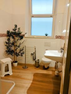 a bathroom with a sink and a toilet and a window at Le Camere di Suleima in Messina +25 photos