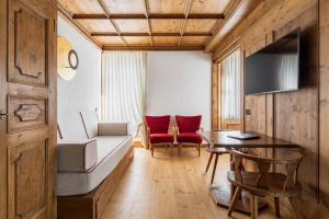 a living room with a couch and a table at Hotel Cortina in Cortina dʼAmpezzo
