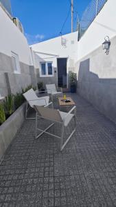 a patio with chairs and a table on a patio at Cascais Garden House 105 in Cascais