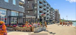 a group of people sitting at tables on a city street at Apartment Aker brygge- Oslo sentrum in Oslo