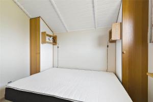 a small room with a bed in it at 17701-Follenslev-Middelvej-2 in Føllenslev
