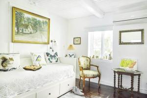 a white bedroom with a bed and a chair at 13301-1-Asnaes-Lindevej-5 in Asnæs