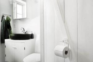 a white bathroom with a sink and a toilet at 13301-1-Asnaes-Lindevej-5 in Asnæs +23 photos