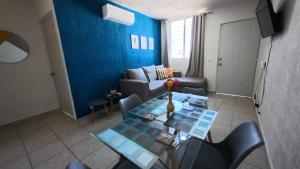 a living room with a table and a couch at Departamento Belinda in Ixtapa