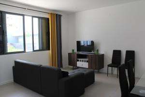a living room with a couch and a tv at Casa Thisolore in Ponta do Sol
