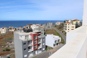 an aerial view of buildings and the ocean at Casa Thisolore in Ponta do Sol