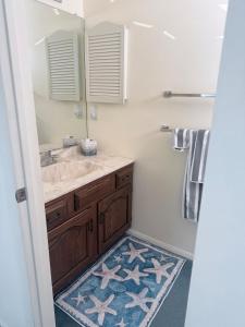 a bathroom with a sink and a mirror at Vermont By The Sea in Cape May +11 photos
