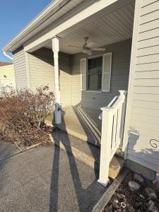 a porch of a house with a white door at Vermont By The Sea in Cape May
