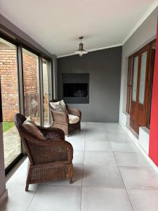 a living room with two chairs and a tv at Spring Day in Piet Retief