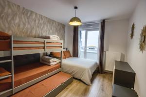 a small bedroom with a bunk bed and a window at Aurelia - Cosy & Chic - 10min Disney - by Cosynousvoici in Chessy