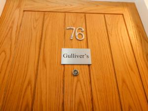a wooden door with a sign on it with the number at Gulliver's in Matlock
