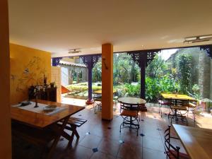 a dining room with tables and chairs and a large window at Hotel Boutique Casa Montalvo Cuenca in Cuenca