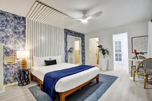 a bedroom with a bed and a blue and white wall at Lucerne Collection Private 4-Unit Building in Lake Worth