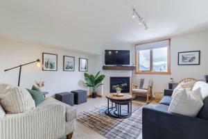a living room with a couch and a table at Morningside - Pet Friendly Stunning Mtn Views in Canmore