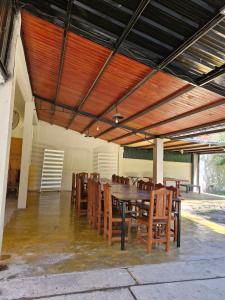 a dining room with a table and wooden chairs at La cañada in Belén
