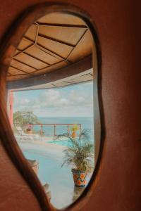 a view of a swimming pool from a window at Private Cliffside Villa with Infinity Pool in Sayulita