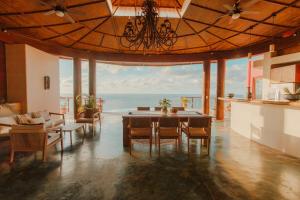 a dining room with a table and a view of the ocean at Private Cliffside Villa with Infinity Pool in Sayulita