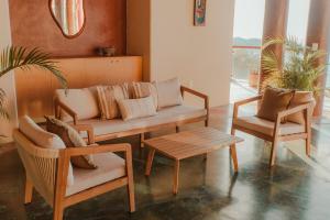 a living room with a couch and two chairs and a table at Private Cliffside Villa with Infinity Pool in Sayulita +27 photos