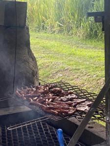 a bunch of meat cooking on a grill at Domaine de Locastel 2 in Morne-à-lʼEau
