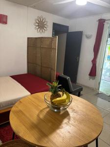 a room with a table with a bowl of bananas on it at Domaine de Locastel 2 in Morne-à-lʼEau +5 photos