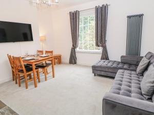 a living room with a table and a couch at Abraham in Matlock