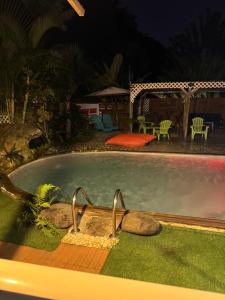 a swimming pool in a yard at night at Domaine de Locastel 2 in Morne-à-lʼEau