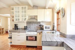 a kitchen with white cabinets and a stove top oven at 12228-Sjaellands-Odde-Strandvaenget-23 in Yderby +18 photos