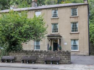 a building with two benches in front of it at Masson in Matlock +7 photos