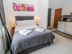 a bedroom with a bed with two towels on it at Masson in Matlock