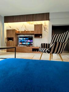 a living room with a couch and a television at Meteora House with a view in Kalabaka