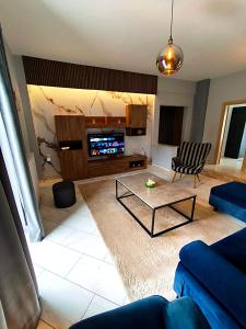 a living room with a couch and a coffee table at Meteora House with a view in Kalabaka