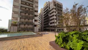 an apartment complex with two tall buildings and a swimming pool at Soho Plaza Hotel in Brasília