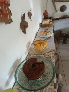 a table with two plates of cakes and pies at Okakoaras Hotel in Paulista