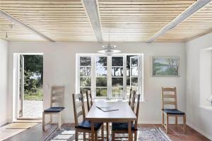 a dining room with a table and chairs at 10081A-Rorvig-Skansehagevej-34 in Rørvig +14 photos