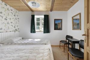 a bedroom with two beds and a table and chairs at 10081A-Rorvig-Skansehagevej-34 in Rørvig