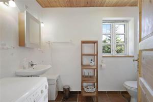 a white bathroom with a sink and a toilet at 10081A-Rorvig-Skansehagevej-34 in Rørvig