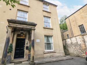a building with a black door in front of it at Arkwright in Matlock
