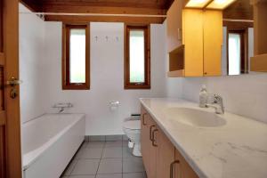 a bathroom with a tub and a toilet and a sink at 12253-Nykobing-Sj-Aeblehegnet-7 in Tjørneholm +22 photos