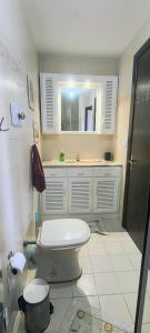 a bathroom with a toilet and a sink and a mirror at 203 Barra Refúgio in Tramandaí +26 photos