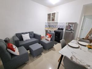 a living room with two couches and a kitchen at Mario Aparta Estudio in San Felipe de Puerto Plata