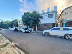 a group of cars parked in front of a building at Mario Aparta Estudio in San Felipe de Puerto Plata