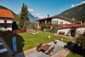 a view of a yard with a house at Hotel Alpina nature-wellness in Wenns