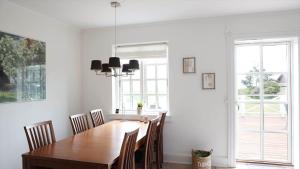 a dining room with a wooden table and chairs at 10098-Rorvig-Fjordvaenget-17 in Rørvig +17 photos