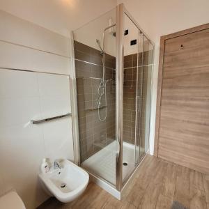 a bathroom with a shower and a toilet and a sink at Casa Gioia Alpina Mountain Lake Iseo Hospitality in Bossico