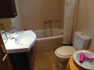 a bathroom with a sink and a toilet and a tub at Giannad suite in Distomo +34 photos